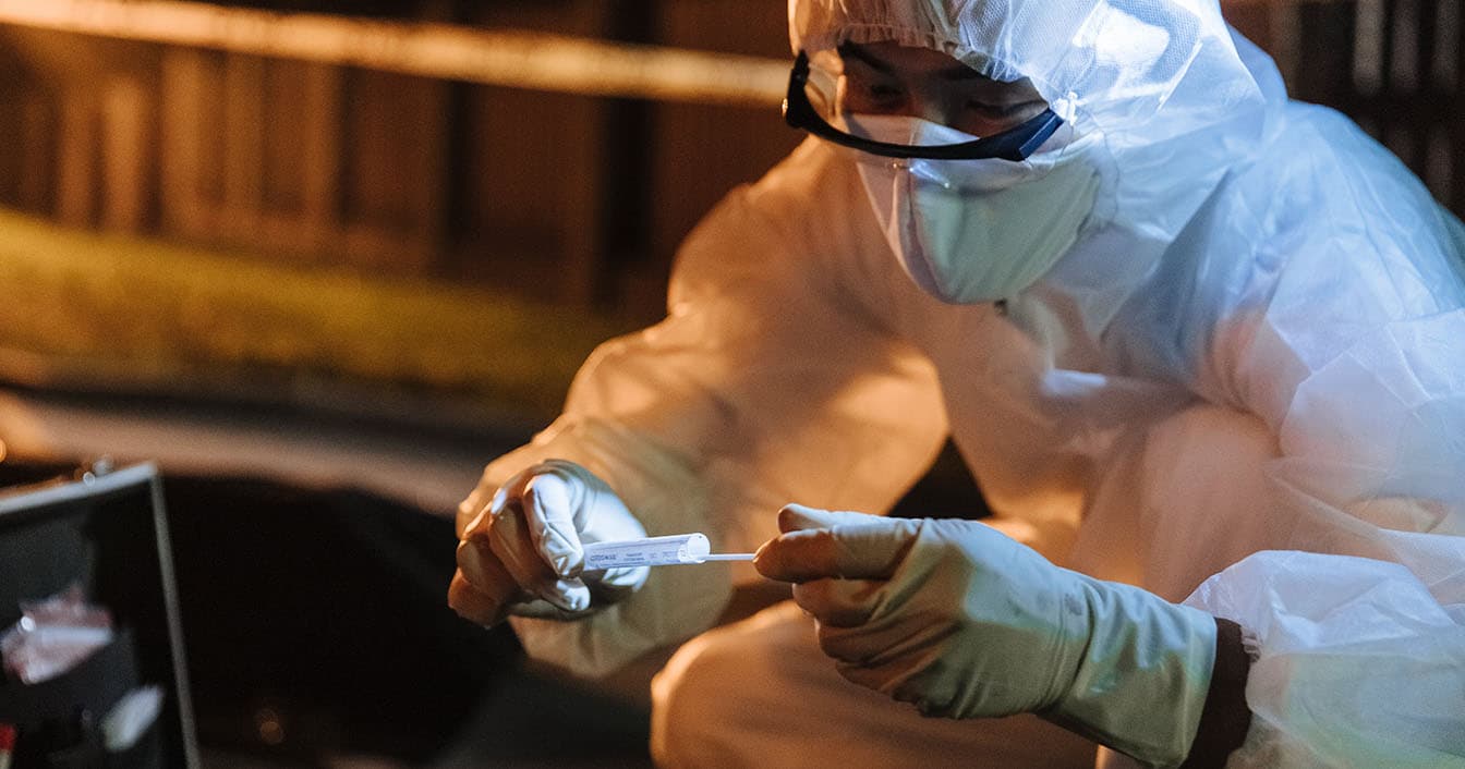 Forensic Professional at a crime scene doing a test